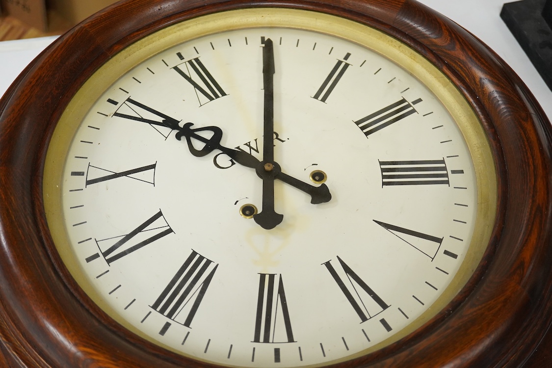 A large 20th century wall clock with platform escapement, the dial painted with GWR, 68cm in diameter